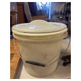Plastic bucket full of vintage wooden clothespins