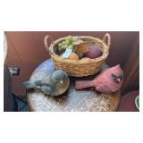 Wicker basket with fake fruit and red/black bird