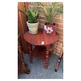 Two-tier rounded side table with red finish
