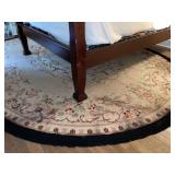 Large oval hooked area rug with floral pattern -