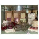 Shelf lot of candles and decor