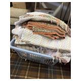 Basket full of woven rugs