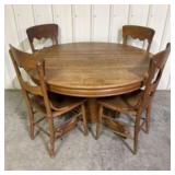 Antique Round Oak Dining Table featuring Carved Cl