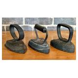 A Trio of Antique Cast Iron Sad Irons