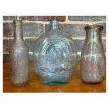 A Trio of Vintage Glass Bottles Including a Washin