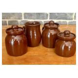 A Set of Four Dark Brown Glazed Stoneware Utility