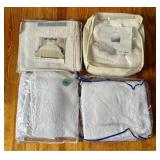 A Collection of White Textured Quilt Sets and Bedd