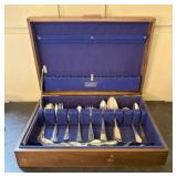 An Assortment of Silverplate Flatware in a Wood St