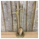 A Set of Brass Fireplace Tools with Stand Featurin
