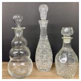 A Trio of Assorted Vintage Clear Glass Decanters