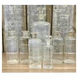 A Collection of Antique Clear Glass Apothecary Bot