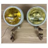 A Pair of Vintage Automotive Fog Lights with Bumpe