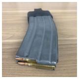A Thirty Round Curved Metal Magazine Fitted with a
