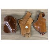 A Trio of Vintage Leather Pistol Holsters Includin