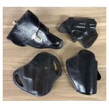 A Collection of Black Leather Firearm Holsters Inc
