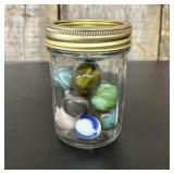 An Assortment of Vintage Glass Marbles in a Clear