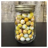 A Collection of Vintage Glass Marbles Housed in a
