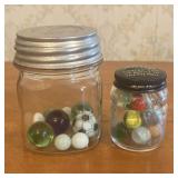 A Pair of Vintage Glass Storage Jars Containing As