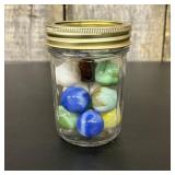 A Collection of Assorted Glass Marbles in a Ribbed
