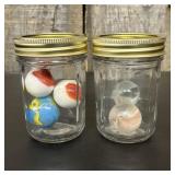 A Collection of Five Glass Shooter Marbles in Two