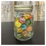 A Collection of Assorted Glass Marbles in a Gradua