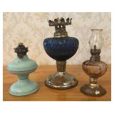 Three Miniature Oil Lamps in Enameled Metal and Gl