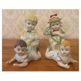 A Group of Four Porcelain Bisque Piano Baby Figuri
