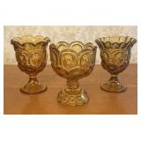 A Trio of Amber Pressed Glass Footed Vessels in th