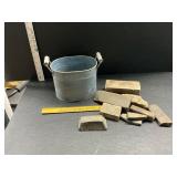Bucket with stones and a block of lead