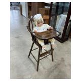 High chair with doll