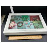 Wooden display case with Christmas jewelry