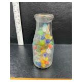 Milk bottle with marbles