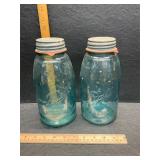 2 half gallon blue jars