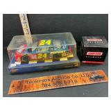 Die cast race car and a helmet