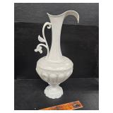 Metal pitcher with cast iron base