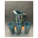 Carnival glass pitcher and glasses