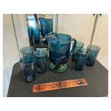 Carnival glass pitcher and glasses