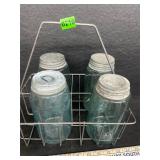 Four blue jars with wire rack / holder
