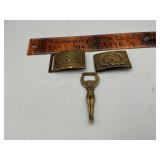 2 belt buckles and a bottle opener