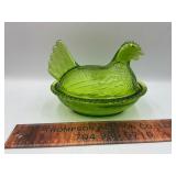 Green hen on the nest