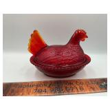Red hen on the nest