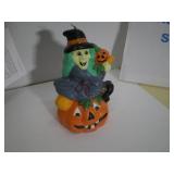 Halloween Witch Sitting on Jack-O-Lantern Candle