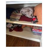 Shelf Contents Including Board Game, Textiles, and