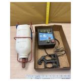 Zareba fence charger and calf bottle with hanger