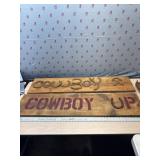 Cowboy Up signs and rack