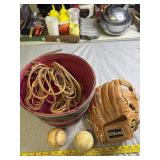 Wilson baseball glove, baseballs, basket and