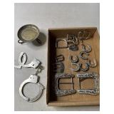Hand cuffs, belt buckles and and belt conchos