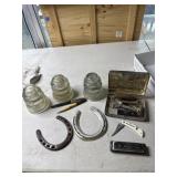Insulators, horse shoes, harmonica, pocket knife