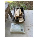 Tote of wood scraps and bag of ice melt