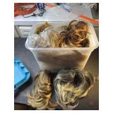 Tote of hair pieces and wigs